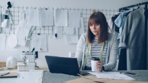 Small business owner doing a pricing review of client invoices