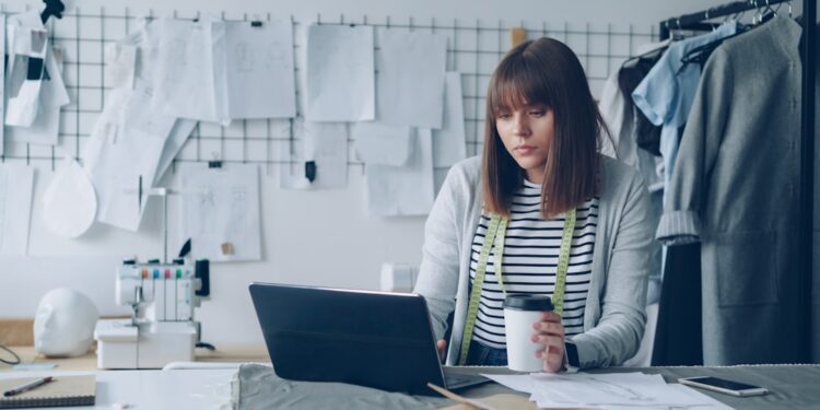 Pricing review before contract renewals photo 1 - STACKwebzine Small business owner doing a pricing review of client invoices