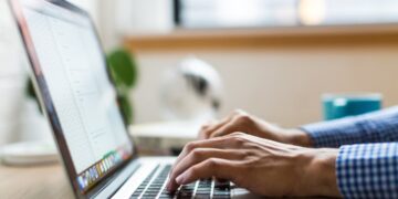 Marketer typing subject lines on a laptop before sending a campaign
