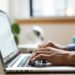 Marketer typing subject lines on a laptop before sending a campaign