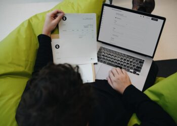 Small business owner checking a hosting bill on a laptop