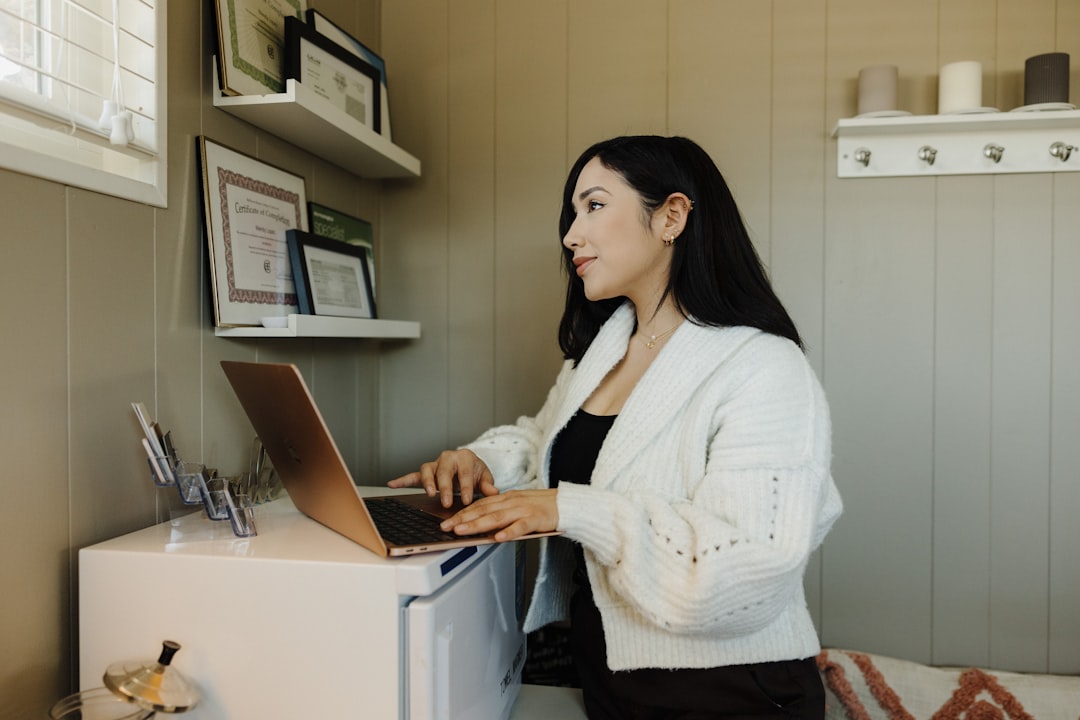 Small business owner reviewing phishing scams warning on a laptop