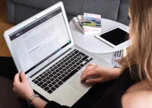 Small business owner comparing page builders on a laptop screen