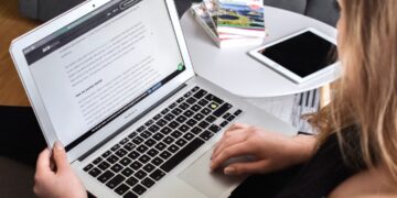 Small business owner comparing page builders on a laptop screen