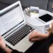 Small business owner comparing page builders on a laptop screen