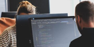 Legacy code checklist for safe retirement — photo 1 - STACKwebzine Developer reviewing legacy code before retiring it in production