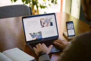 Product manager comparing AI model options on two laptop screens