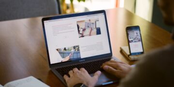 Product manager comparing AI model options on two laptop screens