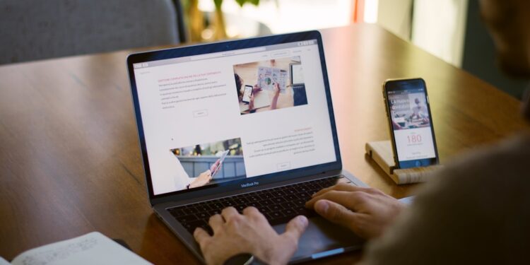 Product manager comparing AI model options on two laptop screens