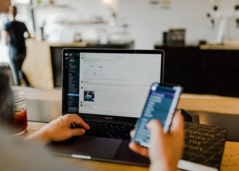 Employee reading suspicious phishing scams message on a work phone