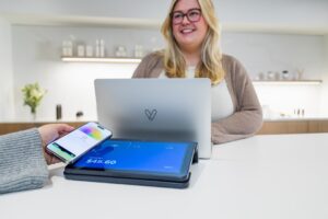 Small business owner reviewing least privilege access settings on a laptop