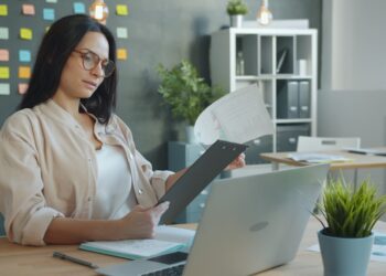 Small business owner checking egress fees on a cloud hosting invoice