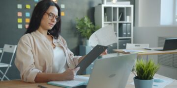Egress fees are quietly reshaping hosting — photo 1 - STACKwebzine Small business owner checking egress fees on a cloud hosting invoice