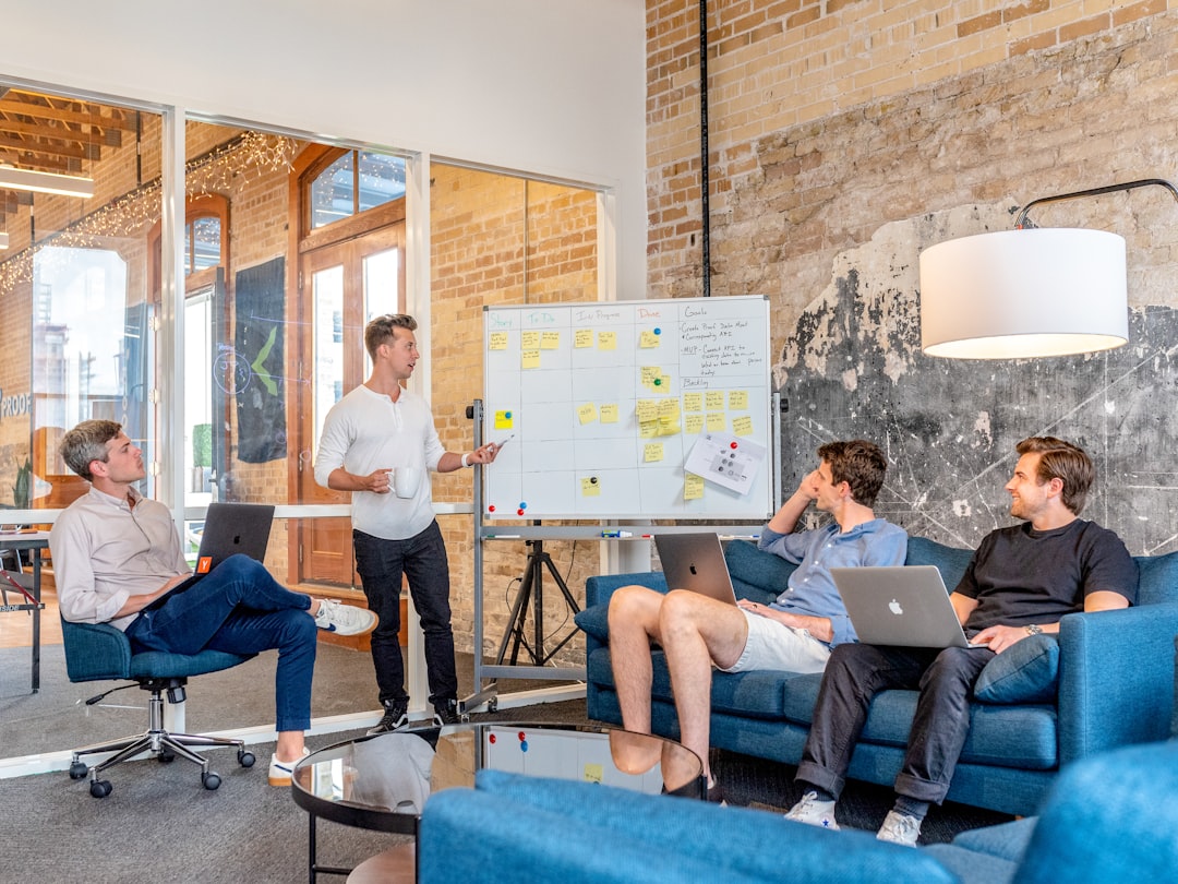 Small team documenting prompt engineering rules on a whiteboard