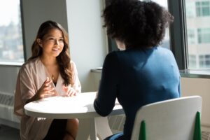 Two colleagues negotiating vendor contracts during an office meet