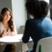 Two colleagues negotiating vendor contracts during an office meet