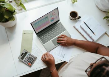 Budget requests justify Q4 software spend photo 1 Finance manager reviewing a Q4 budget requests spreadsheet at a desk