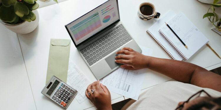 Finance manager reviewing a Q4 budget requests spreadsheet at a desk