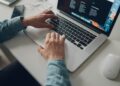 Administrateur IT comparant les tarifs des gestionnaires de mots de passe sur un ordinateur portable