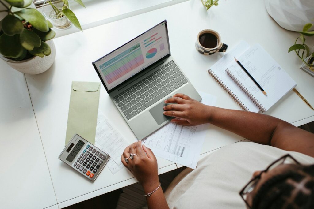 Finance manager reviewing a Q4 budget requests spreadsheet at a desk